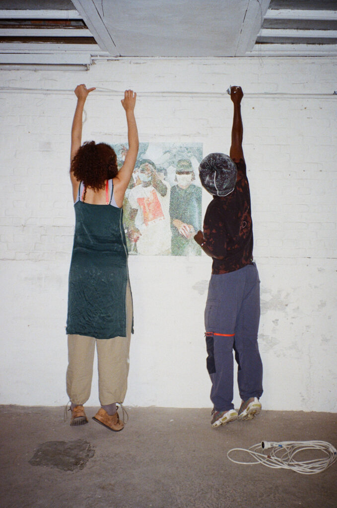 Aya and Collins adjusting lights for Joseph's show in Leuven